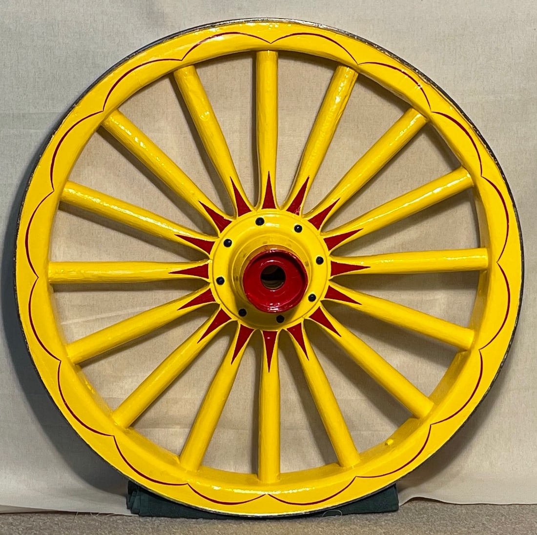 COLORFUL CIRCUS STYLE WAGON WHEEL: Measuring approx. 28” in diameter, with a 3.5” wide rim, and an 8.5” hub, this handsome wooden wheel is in gorgeous shape, and was professionally detailed in Baraboo, WI. This is an