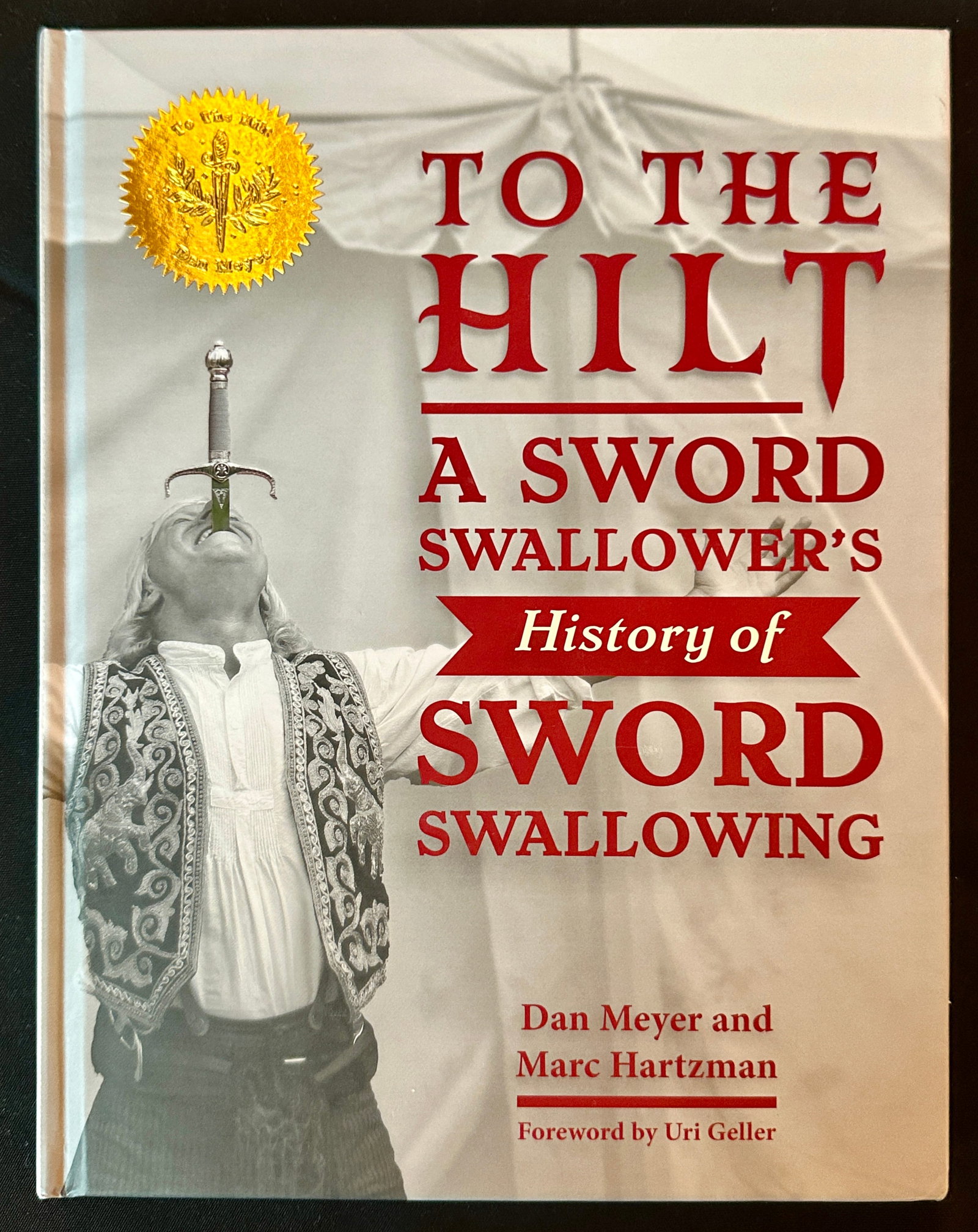 To The Hilt - A Sword Swallorer's History - Meyer and Hartzman: To The Hilt: A Sword Swallower’s History of Sword Swallowing By sword swallower Dan Meyer and sideshow historian Marc Hartzman, with foreword by Uri Geller.To The Hilt is a beautiful special edition