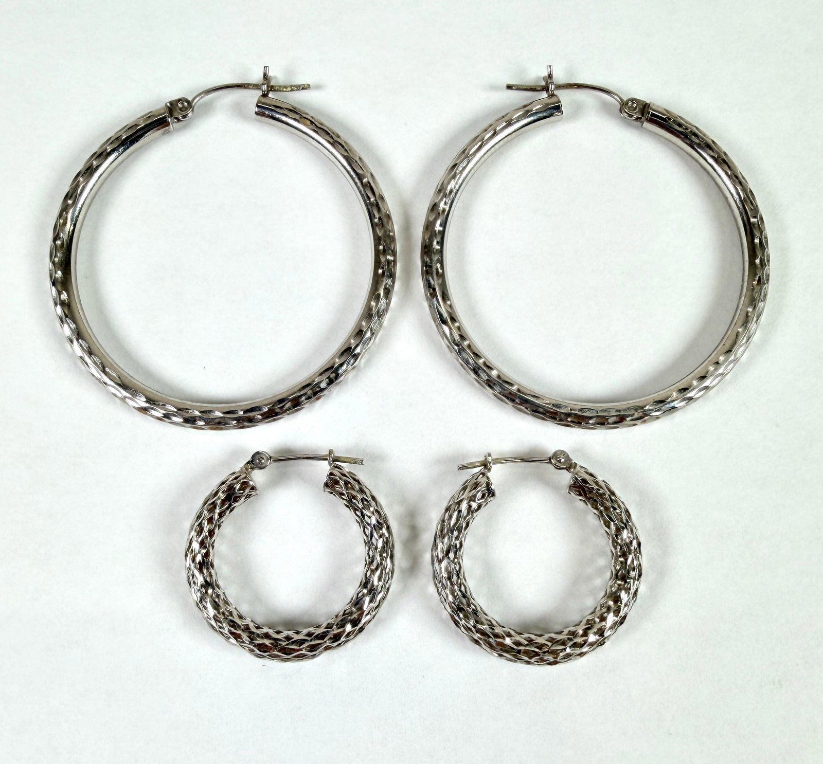 14K WHITE GOLD HOOP EARRINGS: TWO SETS OF HOOP EARRINGS. 6.5 GRAMS IN TOTAL WEIGHT. 1.875" AND 1.5".
