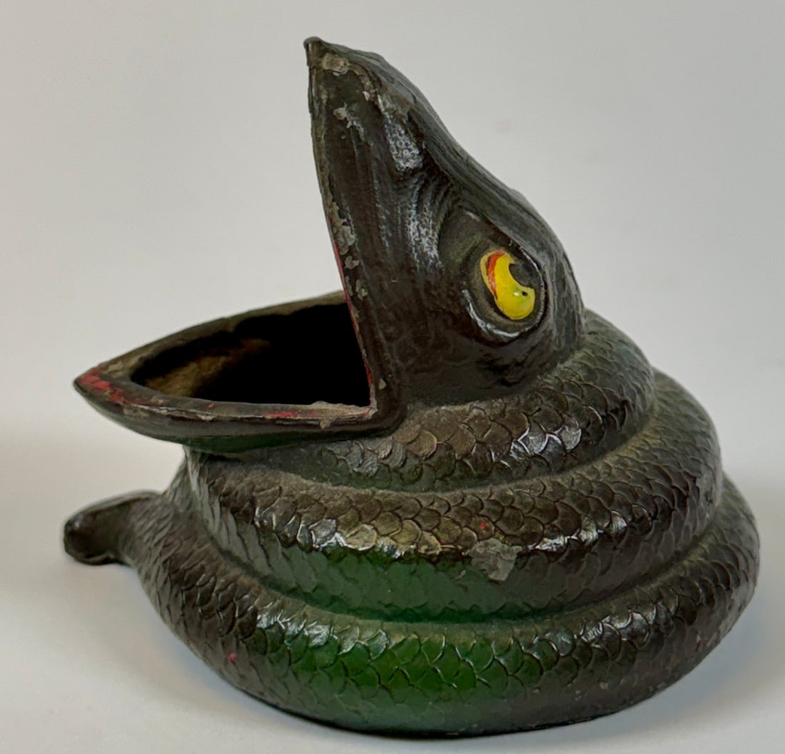 E & J.B. CAST METAL SNAKE: VINTAGE CAST METAL SNAKE-FORM DESK ITEM FOR USE AS WEIGHT, PENCIL OR PAPERCLIP HOLDINGS. SIGNED E & J.B. 3"H