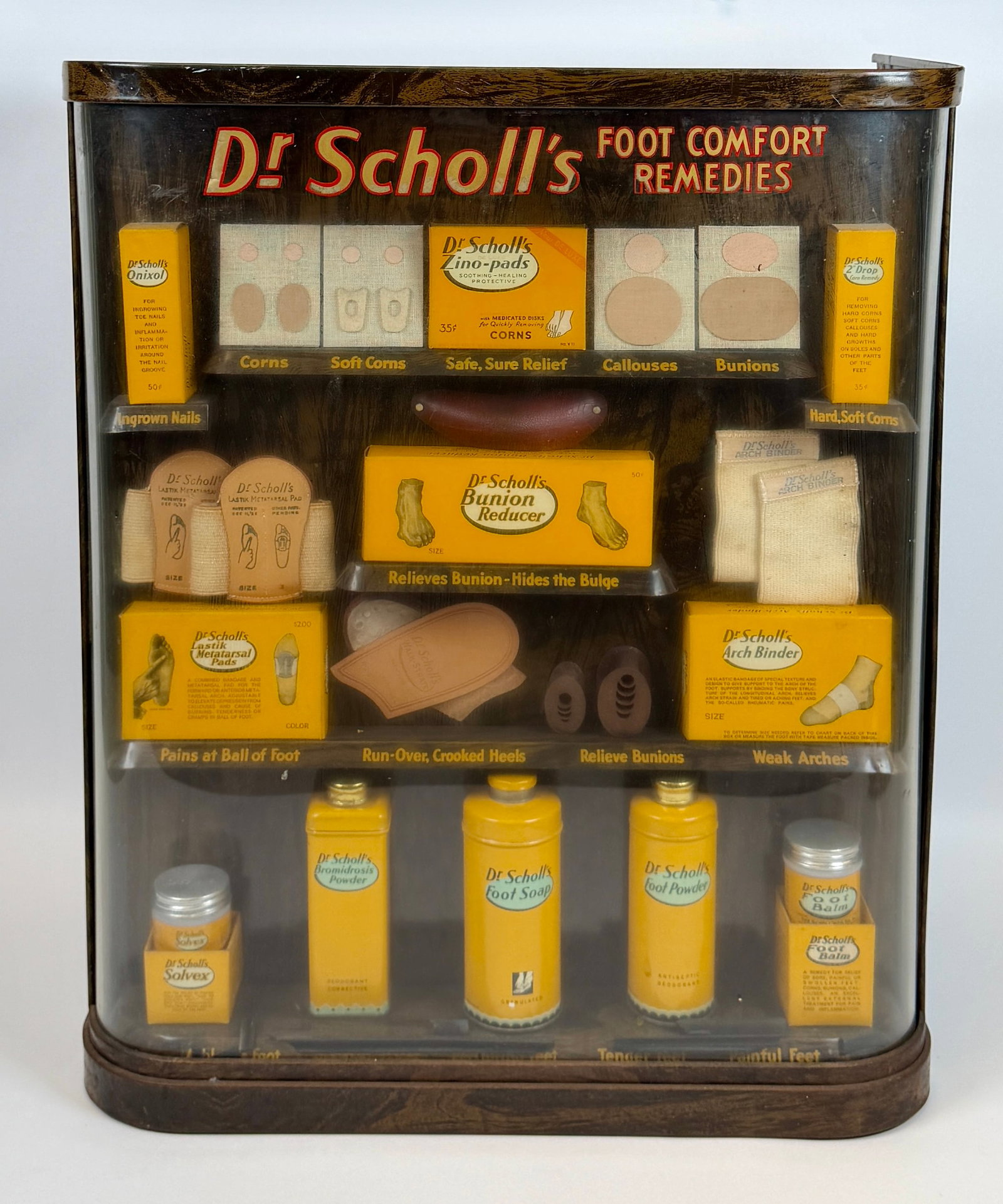VINTAGE DR. SCHOLL'S FOOT CARE DISPLAY: VINTAGE RETAIL PRODUCT DISPLAY FOR DR. SCHOLLS. CABINET WITH PRODUCTS. 21"H, 18"W, 11"D.