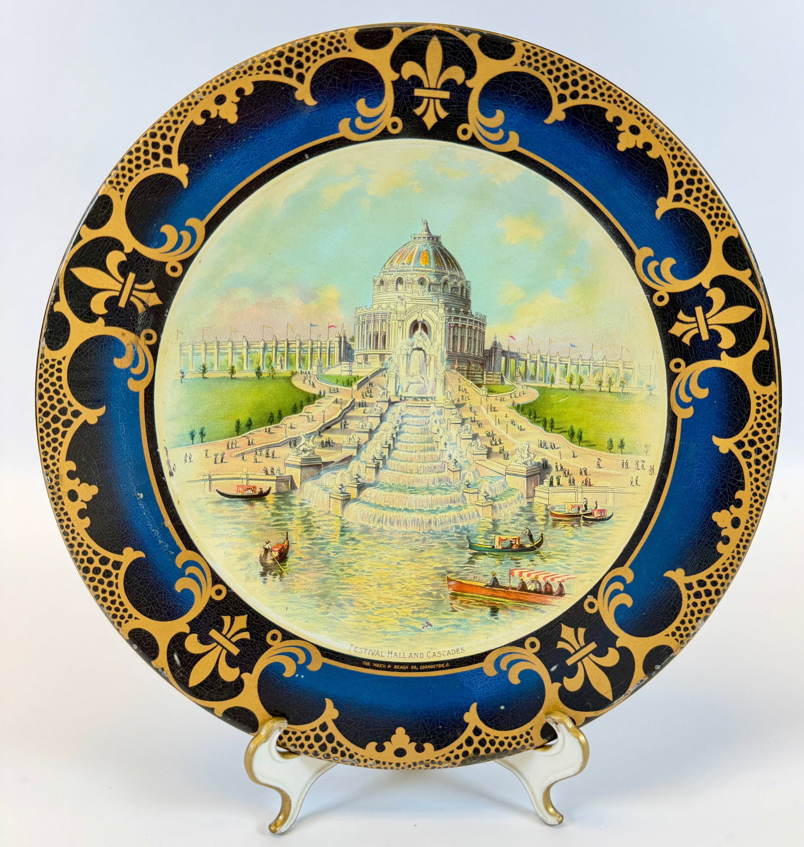 1904 WORLD'S FAIR VIENNA ART PLATE: ADVERTISING. LITHOGRAPHED TIN ART PLATE FEATURING FESTIVAL HALL AND GRAND BASIN. THE MEEK AND BEACH CO. OBVERSE WITH VERY LIGHT CRAQUELURE, REVERSE WITH WEAR MARKS. 10"