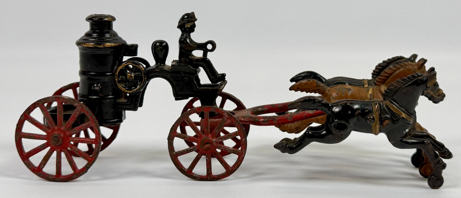 HUBLEY CAST IRON FIRE PUMPER WAGON: CAST IRON HUBLEY (ATTR.) FIRE PUMPER WAGON, HORSES. LIGHT SCATTERED PAINT. UNMARKED. DRIVER WITH REPAIR TO NECK.