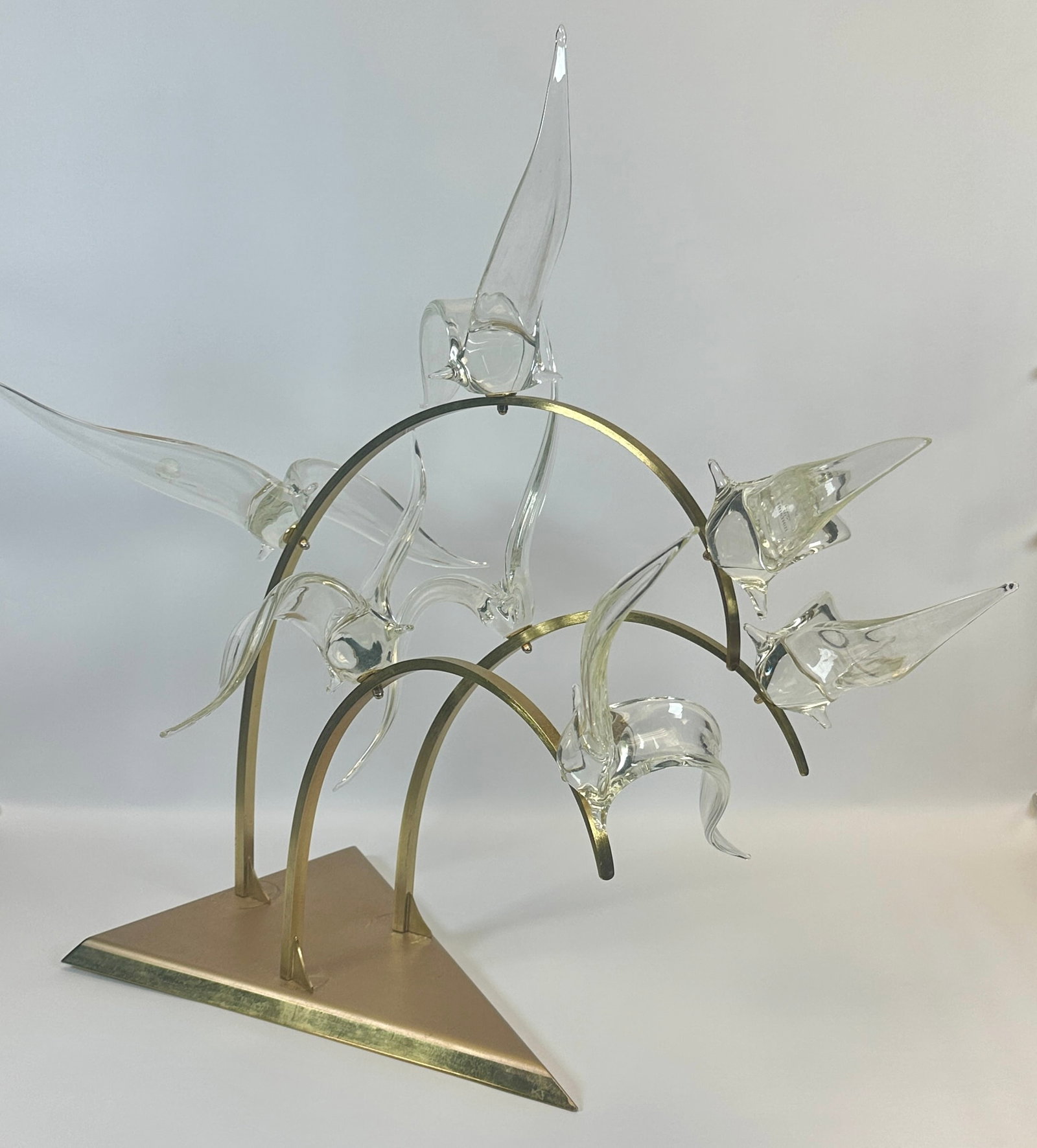 LICIO ZANETTI MURANO ART GLASS BIRD SCULPTURE: LABEL ATTACHED. MULTI-BRASS-ARMS SUPPORTING BIRDS IN FLIGHT. AS SHOWN. 29"H, 30"L, 24"W. REQUIRES THIRD PARTY SHIPPING. CONDITION REPORT AVAILABLE ON REQUEST. CANNOT ISSUE REPORTS WHILE AUCTION IS IN 