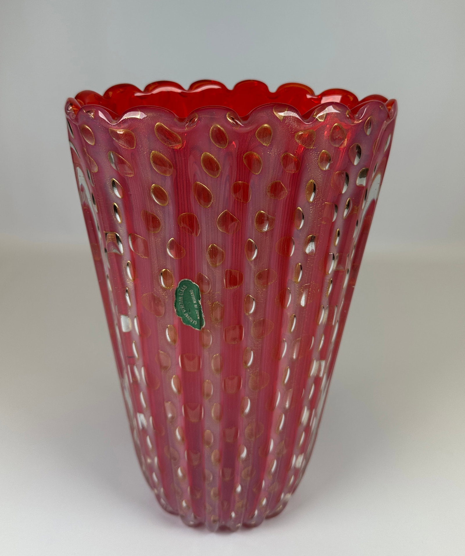 MURANO ART GLASS VASE: RIBBED AND SCALLOPED EDGE, ORANGE GLASS WITH BUBBLES AND GOLD AVENTURINE. LABEL. 11"H. CONDITION REPORT AVAILABLE ON REQUEST. CANNOT ISSUE REPORTS WHILE AUCTION IS IN PROGRESS.