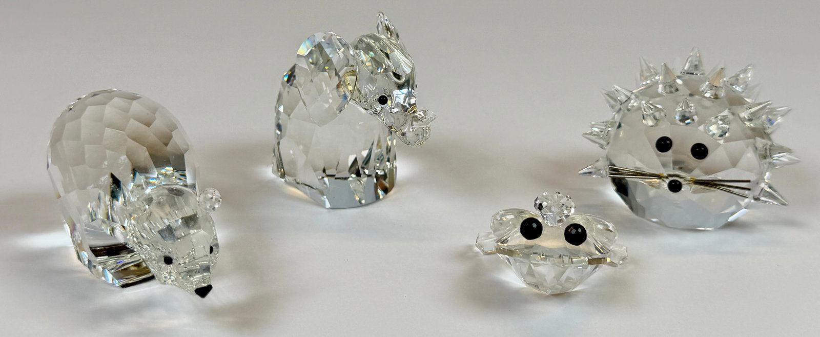 SWAROVSKI CRYSTAL DIMINUTIVE FIGURES: LAND DWELLING ANIMALS INCLUDING POLAR BEAR, ELEPHANT, FROG AND HEDGEHOG. LARGEST 3.5"L. NO BOXES.