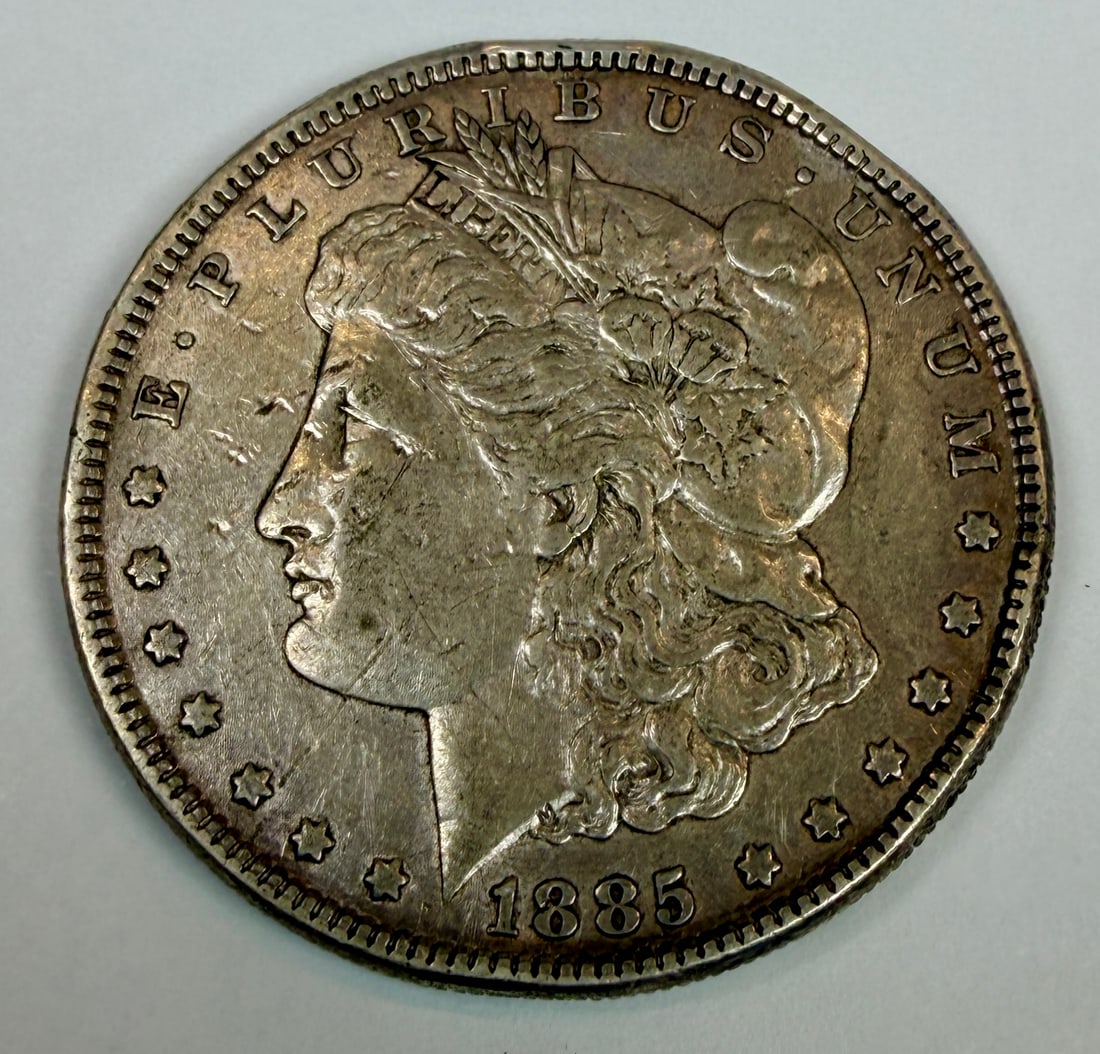 1885-P MORGAN SILVER DOLLAR: CIRCULATED, RIM DINGS.