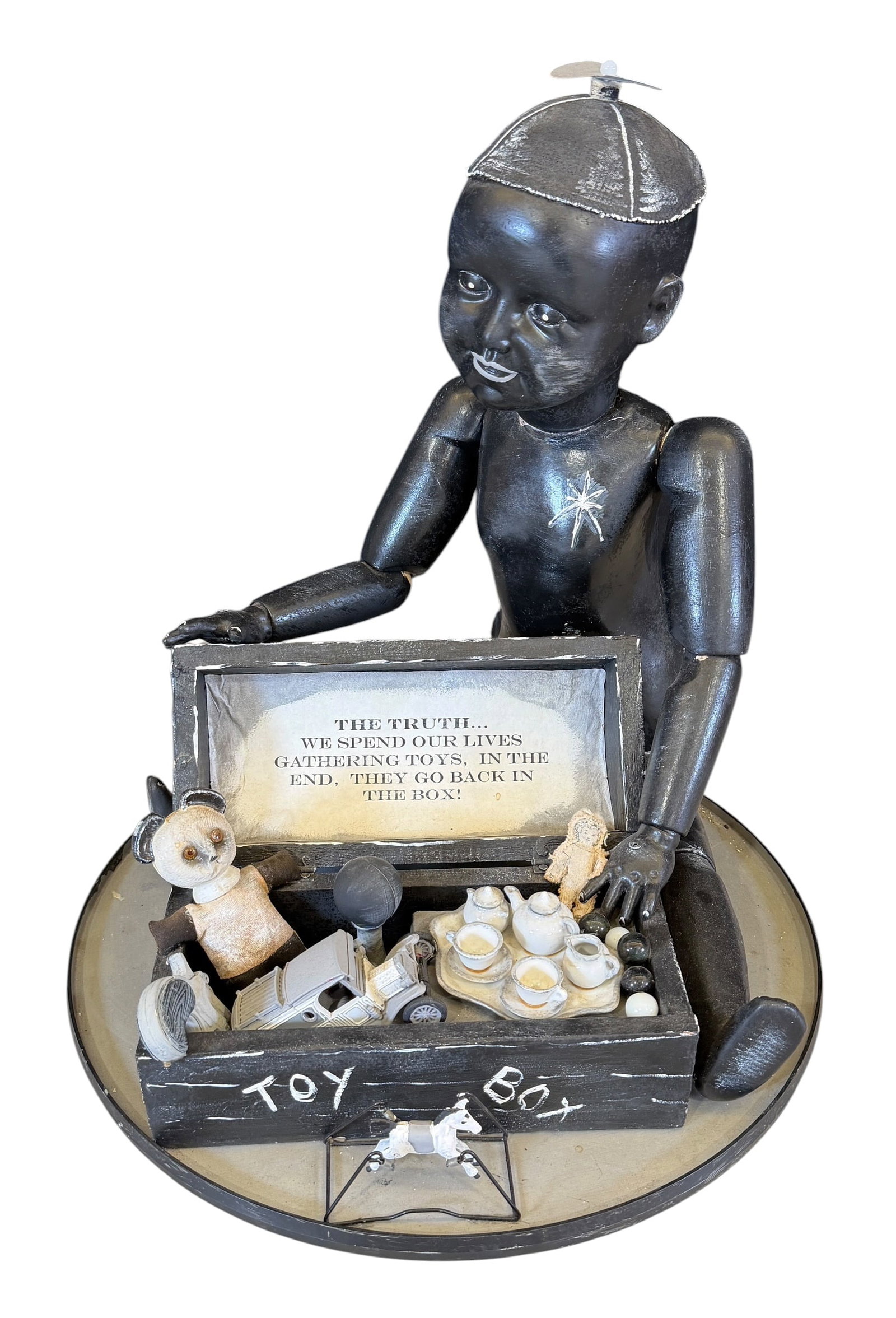 JERRY SHERMAN MIXED MEDIA SCULPTURE - THE TRUTH: JERRY SHERMAN (AMERICAN, CONTEMPORARY) MIXED MEDIA SCULPTURE TITLED: THE TRUTH - WE SPEND OUR LIVES GATHERING TOYS, IN THE END, THEY GO BAC IN THE BOX. 2013. 18"H, 16" DIA.