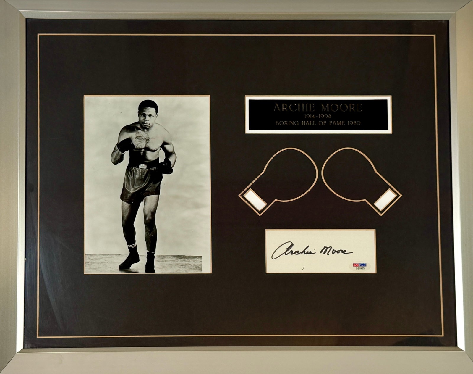 BOXING - ARCHIE MOORE AUTOGRAPH DISPLAY: FRAMED DISPLAY WITH FACSIMILE PHOTOGRAPH, ENGRAVED PLAQUE AND CUT SIGNATURE OF ARCHIE MOORE (1914-1998). MOORE WAS THE LONGEST RUNNING WORLD LIGHT HEAVYWEIGHT OF ALL TIME. CERTIFICATE BY PSA/DNA.