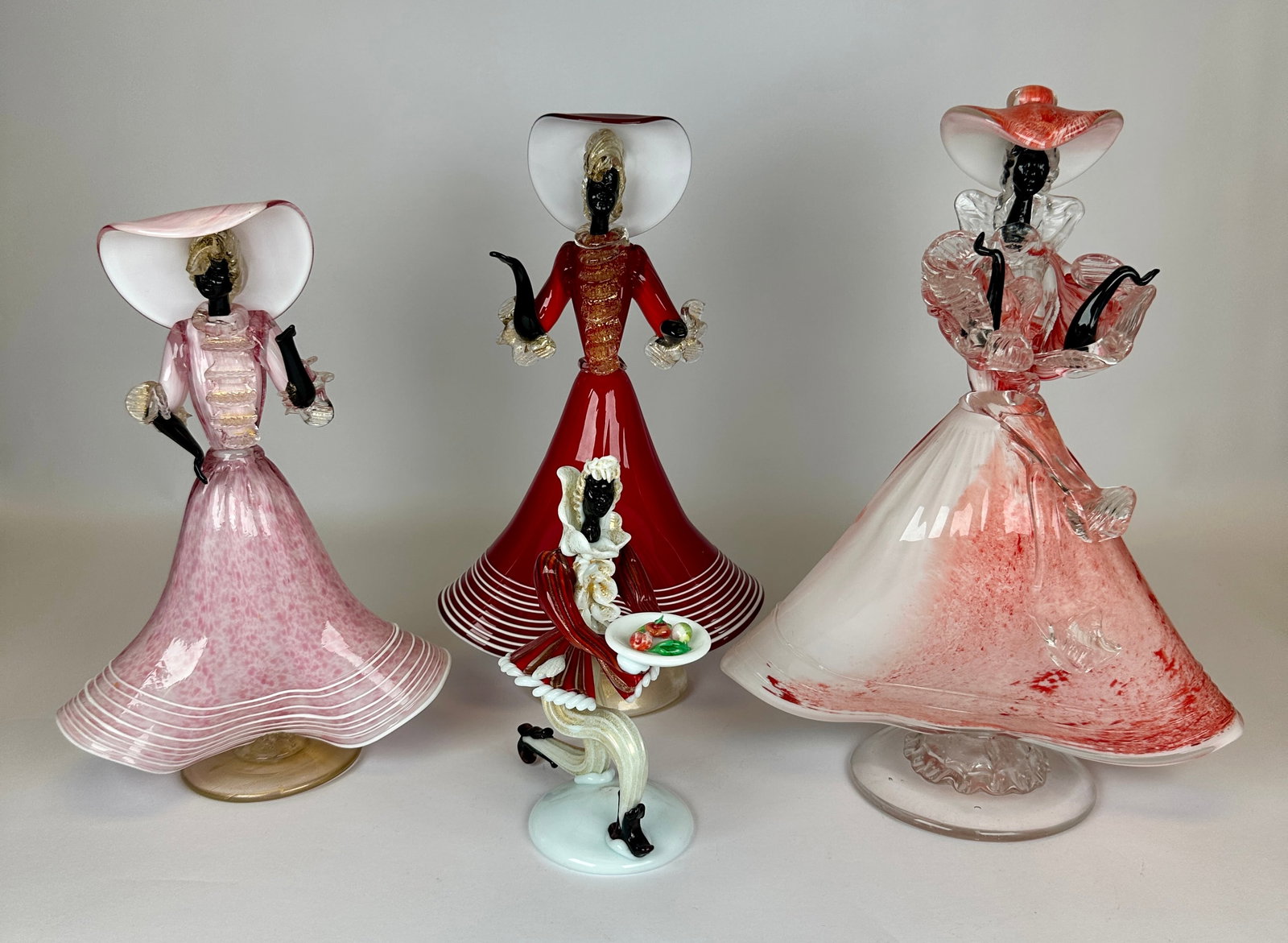 TOFFOLO (ATTR.) MURANO ART GLASS BLACKAMOOR FIGURES: LOT OF FOUR. TALLEST 12"H. REQUIRES THIRD PARTY SHIPPING.