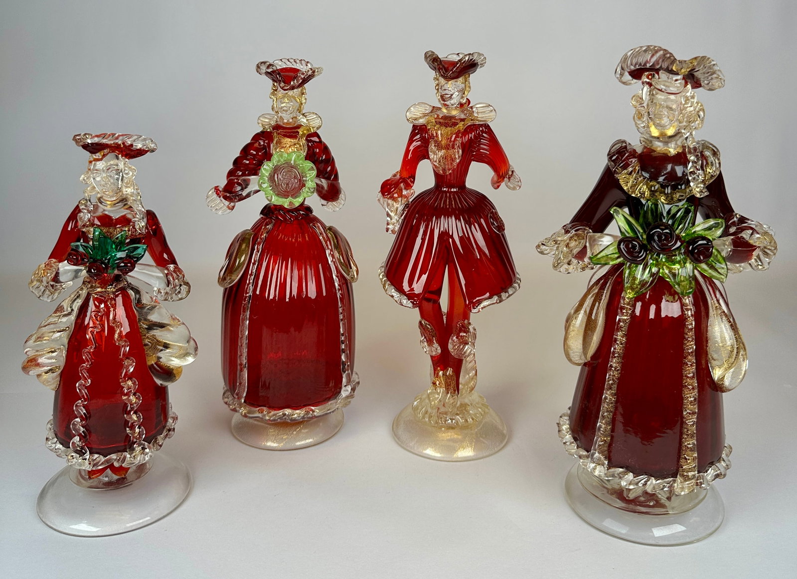 BAROQUE STYLE MURANO ART GLASS FIGURES: LOT OF FOUR. RUBY AND CLEAR GLASS WITH GOLD AVENTURINE. 11"H. REQUIRES THIRD PARTY SHIPPING.