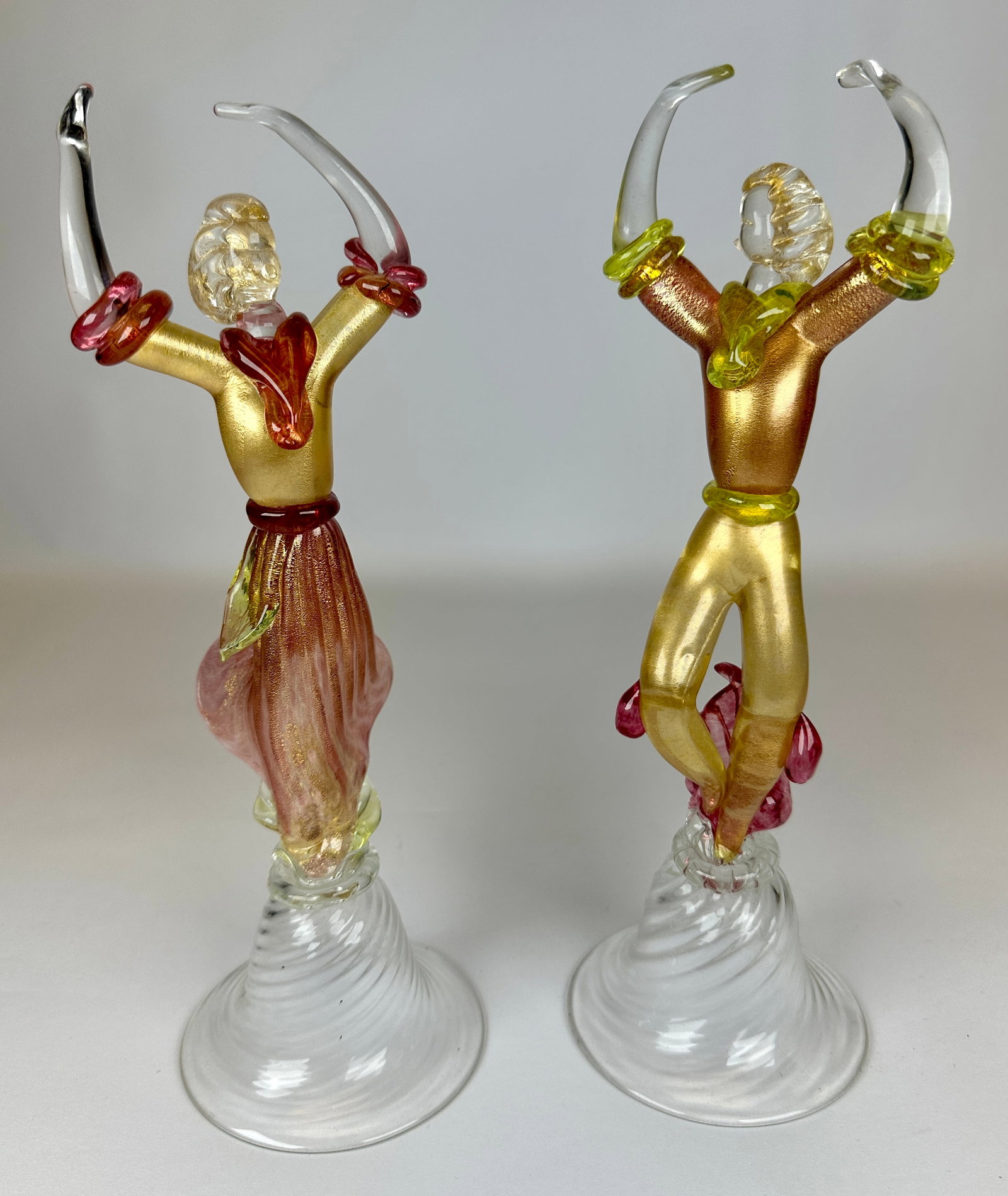 MURANO ART GLASS FLAMENCO DANCERS: PINK, YELLOW AND CLEAR GLASS WITH GOLD AVENTURINE ACCENTS. SWIRL GLASS BASE. 12"H. REQUIRES THIRD PARTY SHIPPING.