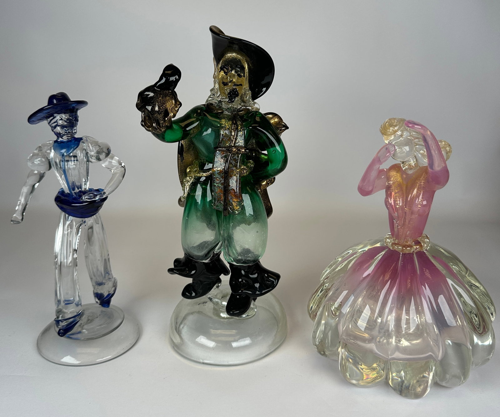 MURANO ART GLASS FIGURES: TRIO OF FIGURES. TALLEST IS 12.5". TIP OF SASH MISSING FROM ONE FIGURE. REQUIRES THIRD PARTY SHIPPING.