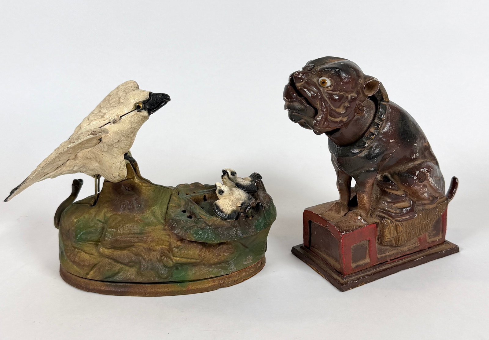 PAIR OF CAST IRON ANIMATED COIN BANKS: BULL DOG BANK AFTER JE STEVENS DESIGN AND BOOK OF KNOWLEDGE EAGLES.
