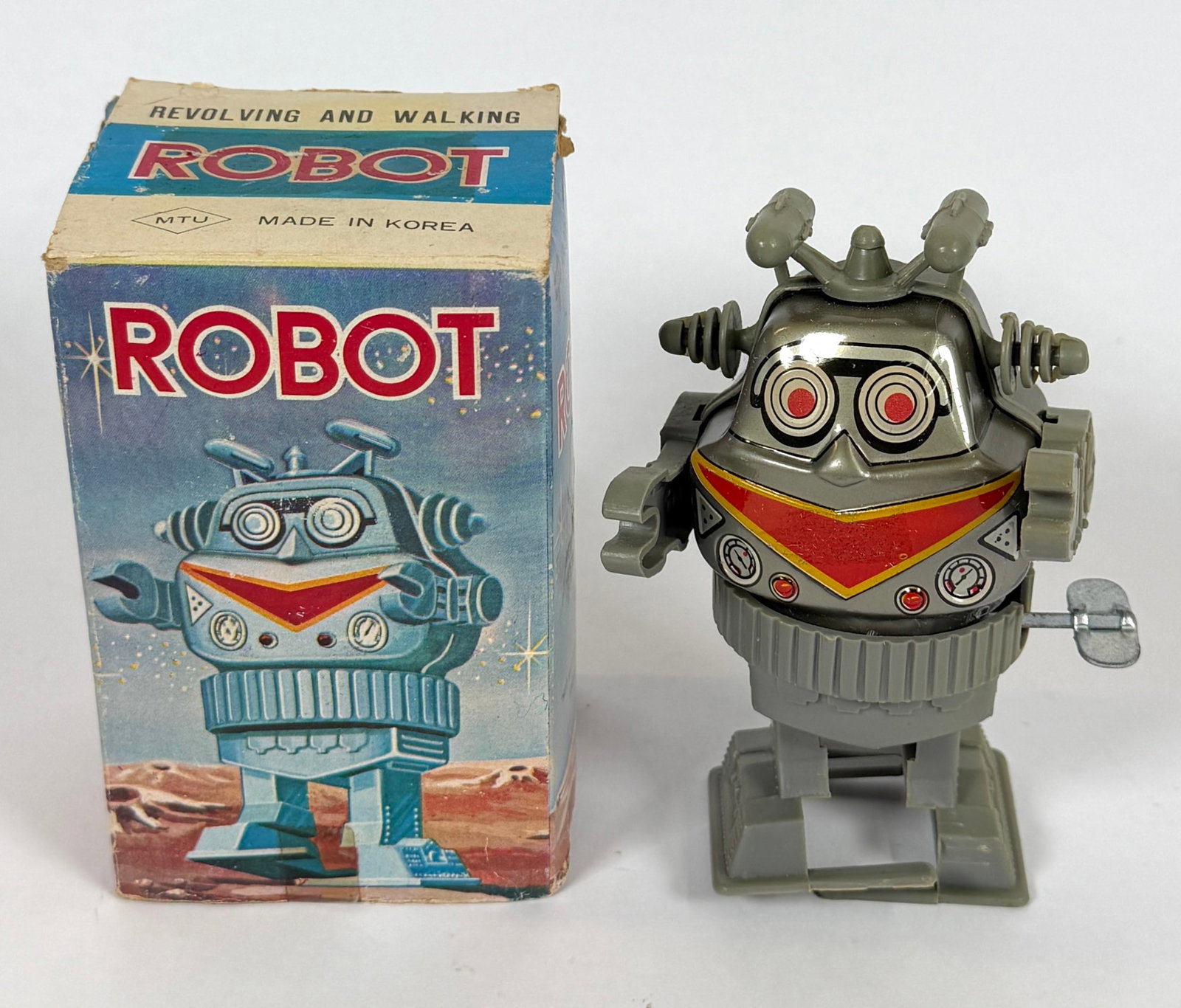 REVOLVING AND WALKING WIND UP TOY ROBOT: MADE IN KOREA, ORIGINAL BOX. 5"H
