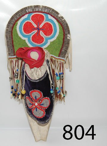 PLATEAU CHILD'S TOY CRADLE: ca. LAST Q 19TH CENT. beaded on hide with beaded apron on cloth, hide drops, has minor bead loss, 18.5" x 8.5".