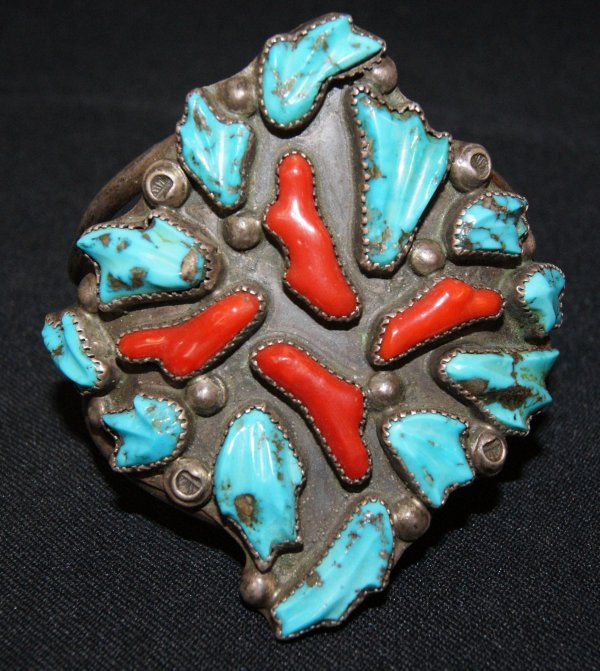 NAVAJO SILVER BRACELET: 1950'S carved turquoise, ox blood coral, 1" opening, 3.75" around, 2.75" wide, attritubed to Dan Simplicio Shipping charge on this item is $10.00. Unless noted all items have some amount of acceptable