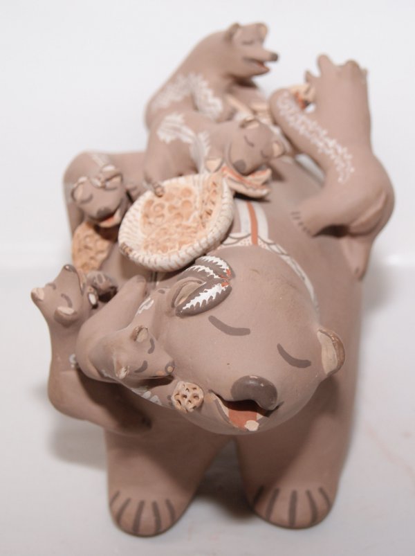 ISLETA POTTERY BEAR: 1990'S story teller, by Robin Telles, 4" x 6" x 4"Shipping charge on this item is $10.00.Unless noted all items have some amount of acceptable wear, scratches, nicks, missing stitches, ect. for their