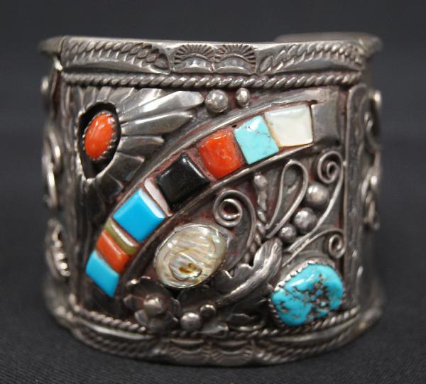 Navajo Cuff Bracelet: 1970s-80s sterling silver with abalone, turquoise, coral, jet and shell, 5.25" x 2.25" 1.25" opening Shipping charge on this item is $10.00. Unless noted all items have some amount of acceptable wear,