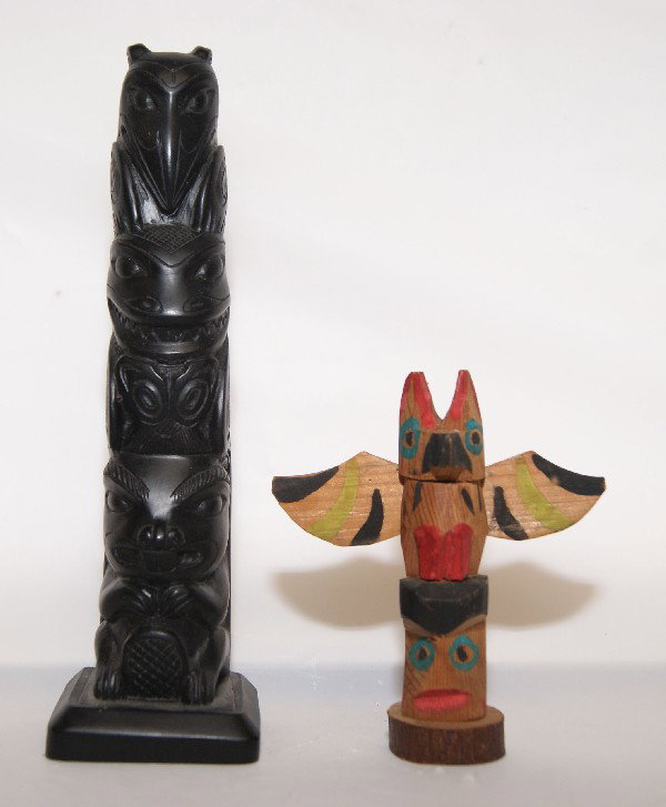 Two Northwest Coast Totem Poles: 1980s one cast one carved wood, 6.75" tall and 3.5" tall Shipping charge on this item is $10.00. Unless noted all items have some amount of acceptable wear, scratches, nicks, missing stitches, ect. fo