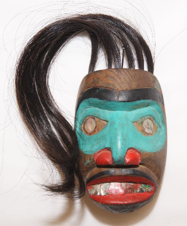 Northwest Coast Frontlet: 1980s hand carved wood and painted, 3.5" x 2.5" without hairShipping charge on this item is $10.00.Unless noted all items have some amount of acceptable wear, scratches, nicks, missing stitches, ect.