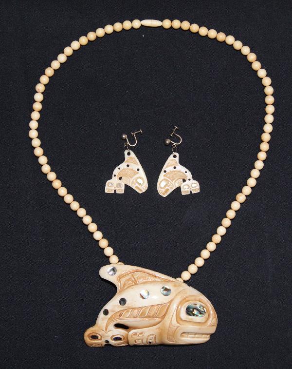 Cherokee Pendant Necklace: 1970s carved ivory killer whale with inlaid abalone signed Patty Fawn with ivory beads 25" long, pendant 2.5" x 4.25" Shipping charge on this item is $10.00.