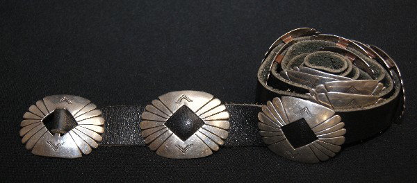 Navajo Concho Belt: 1960s 70s sterling silver, 12 oval concho's 1.5" x 2" open center 36 inches long Shipping charge on this item is $10.00.