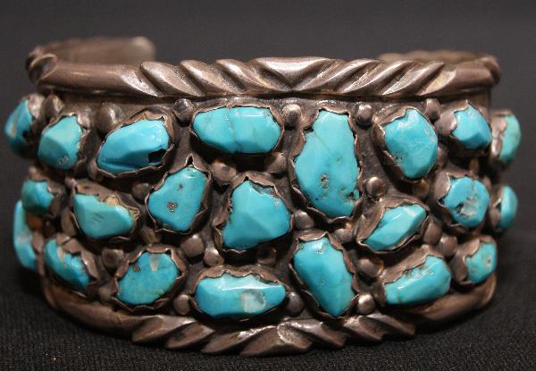 Navajo Bracelet: 1960s 70s sterling Silver with hand cut and filed turquoise stones signed A.Penketewa 5.25" x 1.5" x 1" opening Shipping charge on this item is $10.00. Unle