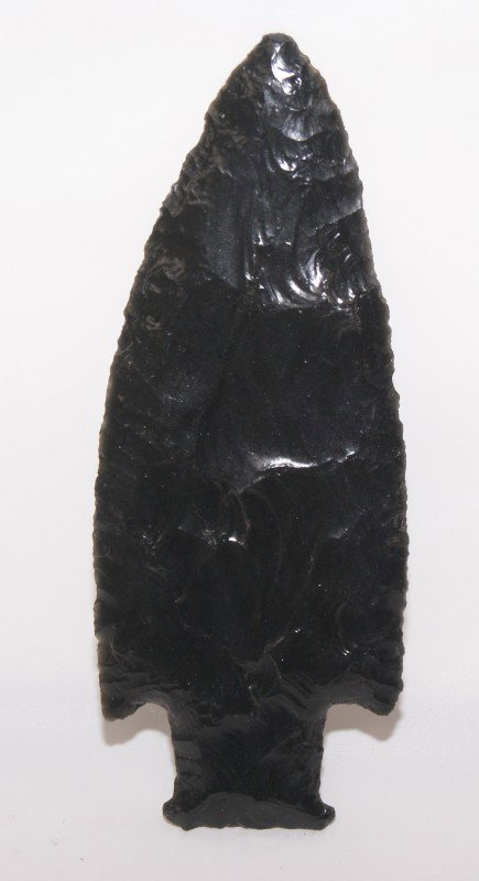 CALIFORNIA SPEAR POINT: age unknown made of obsidian, 5.25" x 2" Shipping charge on this item is $10.00. Unless noted all items have some amount of acceptable wear, scratches, nicks, missing stitches, ect. for their age. Mea