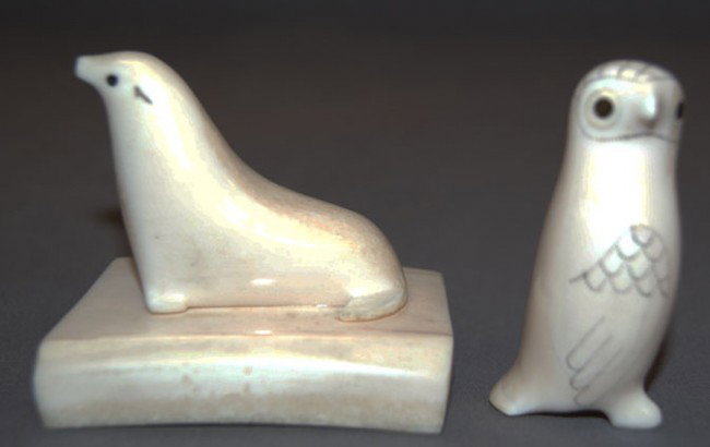 TWO ESKIMO CARVINGS: 1940-50s carved ivory seal on ivory base penguin is scrimshawed both have inlaid eyes, 2" x 2.5"/2" x 1" Shipping charge are for the United States. The shipping on this lot is $10.00. Outside the Unit