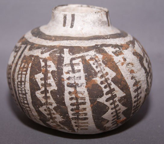 SNOWFLAKE POTTERY JAR: prehistoric child size black on white as found condition, 3" x 3.5" Shipping charge are for the United States. The shipping on this lot is $10.00. Outside the United States there will be additional sh
