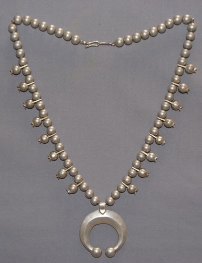 NAVAJO SQUASH BLOSSOM NECKLACE: 1960s 70s sterling Silver standard cast naja, 26" long Shipping charge are for the United States. The shipping on this lot is $10.00. Outside the United States there will be additional shipping fees. 