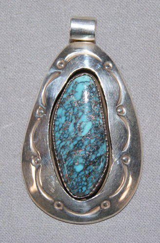 NAVAJO SILVER PENDANT: 1980s shadow box style with turquoise settings signed MG, 1.75" long Shipping charge are for the United States. The shipping on this lot is $10.00. Outside the United States there will be additional s