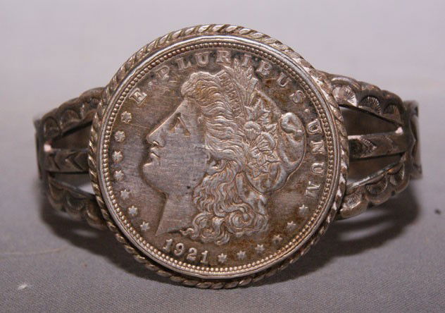 NAVAJO SILVER BRACELET: 1970s silver with a 1921 Silver Dollar, .5" X 6" X 1" opening Shipping charge are for the United States. The shipping on this lot is $10.00. Outside the United States there will be additional shipping