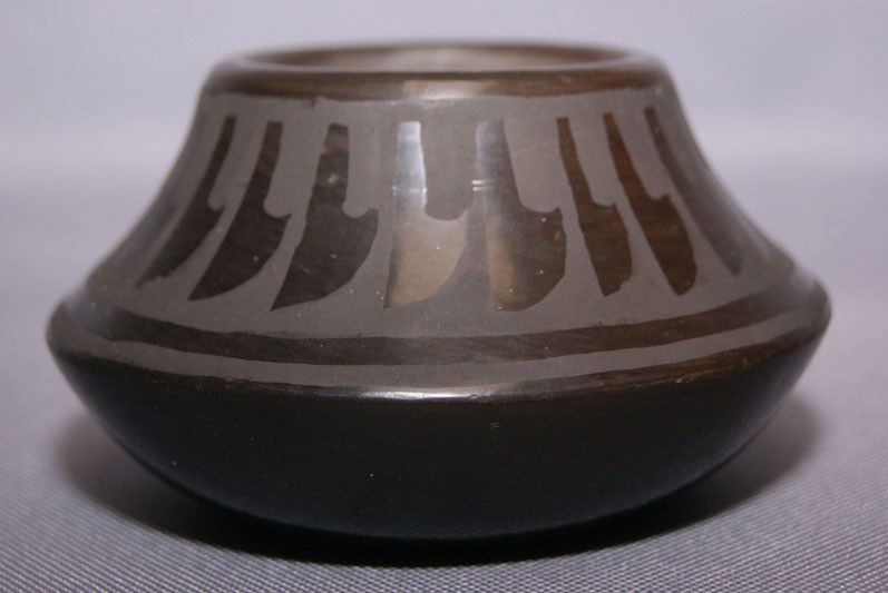 SAN ILDEFONSO POTTERY JAR: 1970's Matt on black geometric design has minor rubbing signed Alice Martinez, 2.5" X 4" Shipping charge are for the United States. The shipping on this lot is $10.00. Outside the United States there