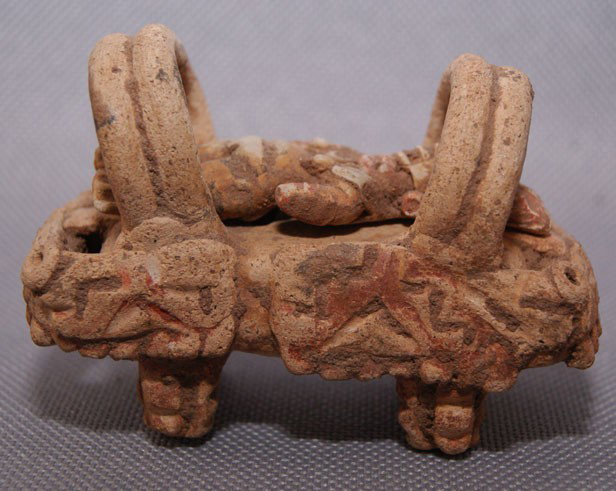 CHUPICAURO POTTERY IDOL: 300 BC pottery cradle with figure, 1.5" x 2.5" Shipping charge are for the United States. The shipping on this lot is $10.00. Outside the United States there will be additional shipping fees. Unless n