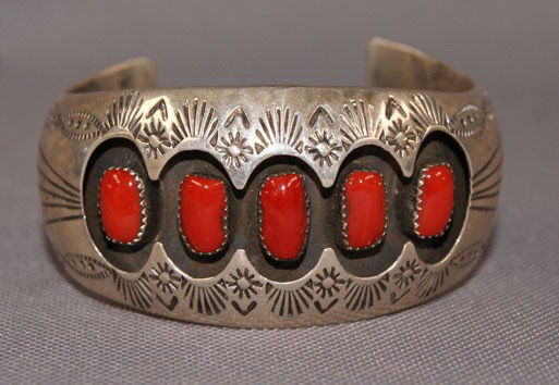 NAVAJO BRACELET: 1970s 80s sterling silver and coral hand stamped design shadowbox style 1.5" x 5" 1.25 opening Shipping charge are for the United States. The shipping on this lot is $10.00. Outside the United States 