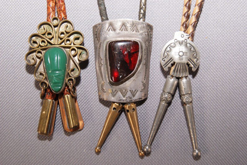 COLLECTION OF BOLOS: 1970s 80s two are Navajo sterling silver one Mexican brass and jade, largest one 1.75" x 1.25" Shipping charge are for the United States. The shipping on this lot is $10.00. Outside the United States 