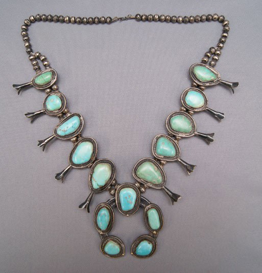 NAVAJO SQUASH BLOSSOM NECKLACE: 1960s 70s sterling silver and turquoise has cracked stone 29 inches long Shipping charge are for the United States. The shipping on this lot is $10.00. Outside the United States there will be addition