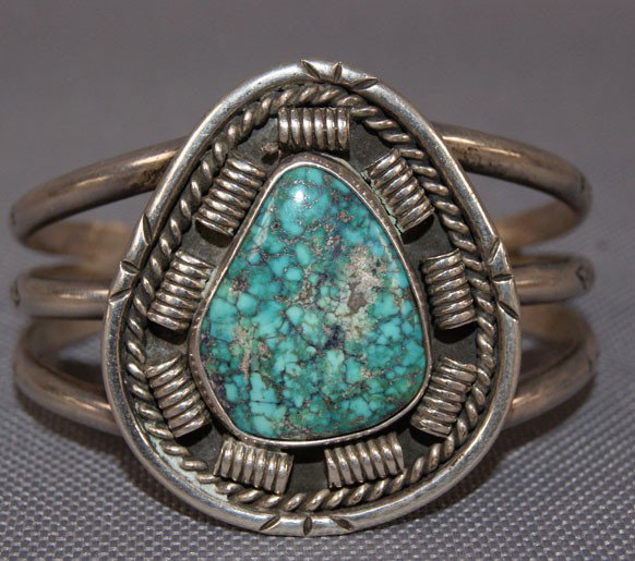 NAVAJO BRACELET: 1970s 80s sterling silver single turquoise stone marked with Hallmark 4.75" x 1.75" x 1.25" Shipping charge are for the United States. The shipping on this lot is $10.00. Outside the United States the