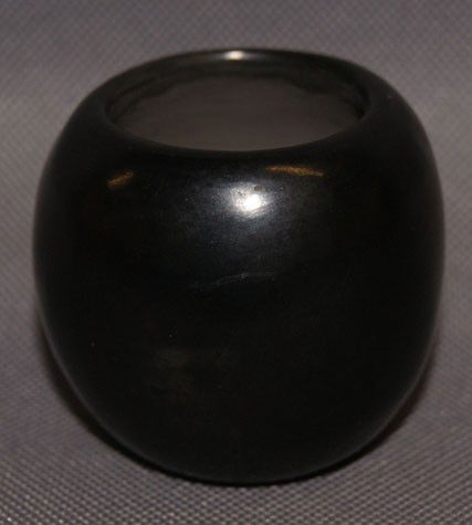 San Ildefonso pot: 1973 stone polished black ware by Stahn-Moo-Whe Barbara Gonzales, 1.75" x 2" Shipping charge are for the United States. The shipping on this lot is $10.00. Outside the United States there will be addi