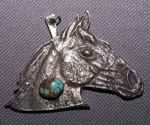 Navajo silver pendant: 1960s 70s Sandcast single turquoise setting signed D. Begay, 1.75" x 2.25" Shipping charge are for the United States. The shipping on this lot is $10.00. Outside the United States there will be additi