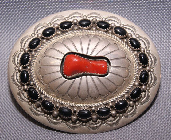 Navajo silver buckle: 1970s 80s stamp design shadowbox coral setting and jet stones signed W.M., 3" x 2.5" Shipping charge are for the United States. The shipping on this lot is $10.00. Outside the United States there will