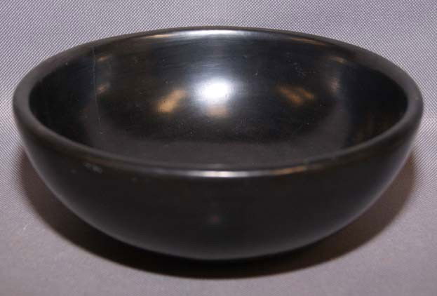 SAN ILDEFONSO POTTERY BOWL: 1970s polished black ware has cracks signed Maria Poveka 2.5 x 7" Shipping charge are for the United States. The shipping on this lot is $10.00. Outside the United States there will be additional ship