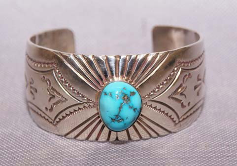 NAVAJO SILVER BRACELET: 1970s- 80s stamped design with single turquoise setting 5.5 x 1" x 1" Shipping charge are for the United States. The shipping on this lot is $10.00. Outside the United States there will be additional 