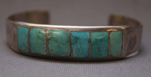 NAVAJO TURQUOISE AND SILVER BRACELET: 1970s 80s with channel inlaid turquoise 5" x .5" x 1" Shipping charge are for the United States. The shipping on this lot is $10.00. Outside the United States there will be additional shipping fees. U