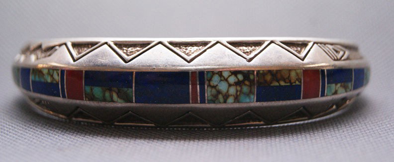 ZUNI BRACELET: 1980s 90s hand stamped sterling silver with channel inlayed shadow box design signed with logo, 6.25" x .75" x 1" Shipping charge are for the United States. The shipping on this lot is $10.00. Outside