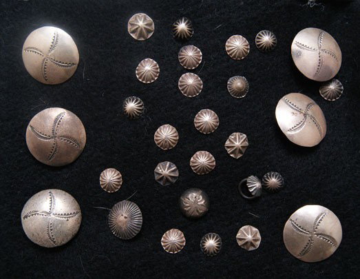 COLLECTION OF NAVAJO BUTTONS: 1960s 70s approximately 29 sterling silver hand stamped design, largest 1" diameter smallest .25" diameter Shipping charge are for the United States. The shipping on this lot is $10.00. Outside the Un