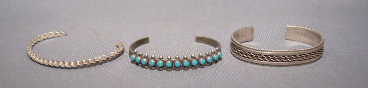 THREE BRACELETS: 1970s 90s all are sterling silver one has turquoise stones, largest 5" x .5" x 1" opening Shipping charge are for the United States. The shipping on this lot is $10.00. Outside the United States there