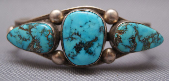 NAVAJO BRACELET: 1970s 80s sterling silver hand stamped design with three turquoise stones, 5.25" x 1.25" 1 inch Shipping charge are for the United States. The shipping on this lot is $10.00. Outside the United States